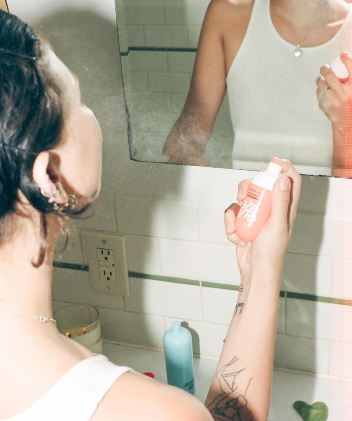 Person applying refreshing toner for oily skin.