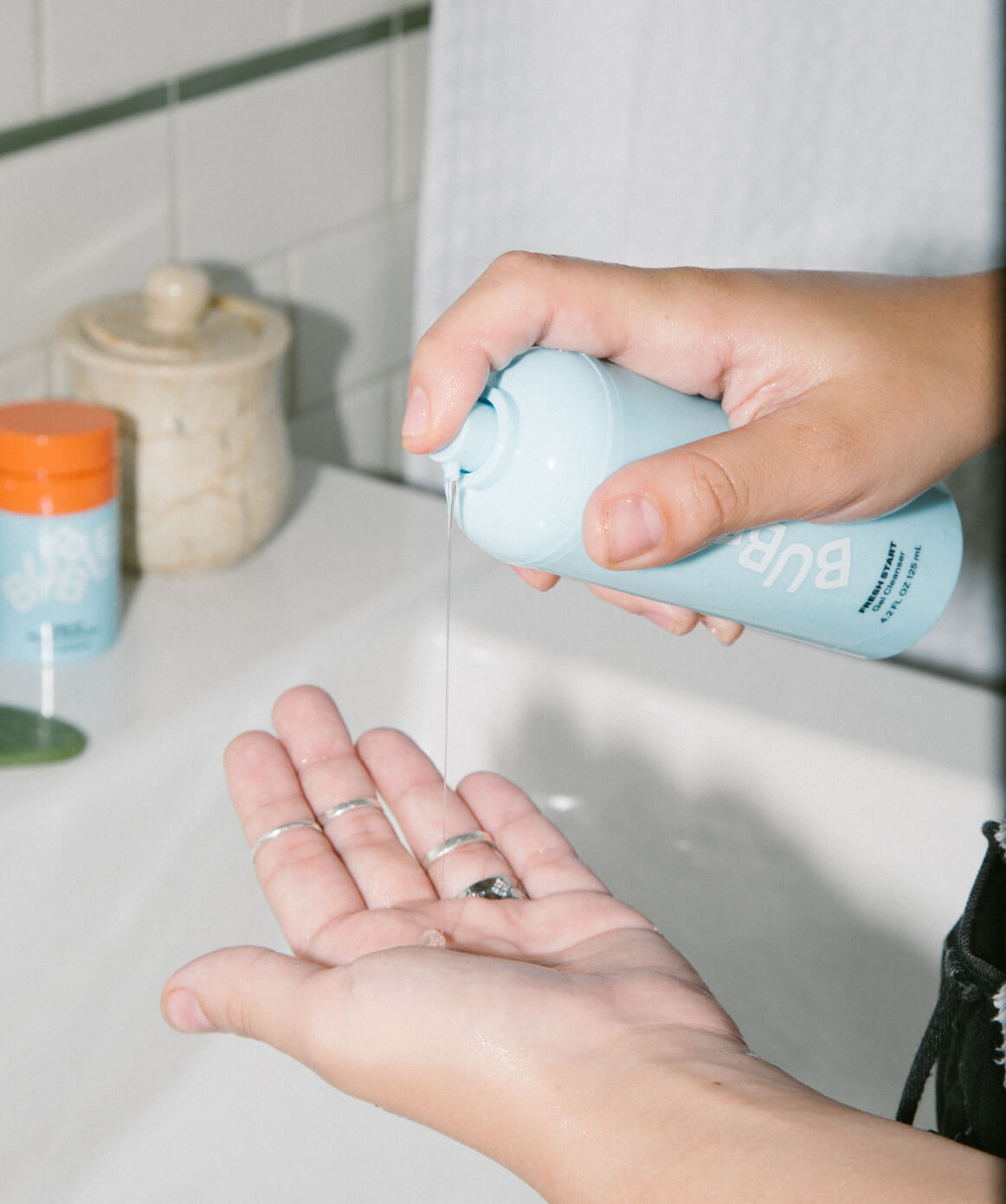 close up of person squeezing gel cleanser onto hands